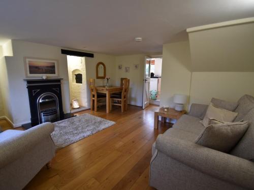 a living room with a couch and a fireplace at 1 Bed in Wool DC153 in Wool