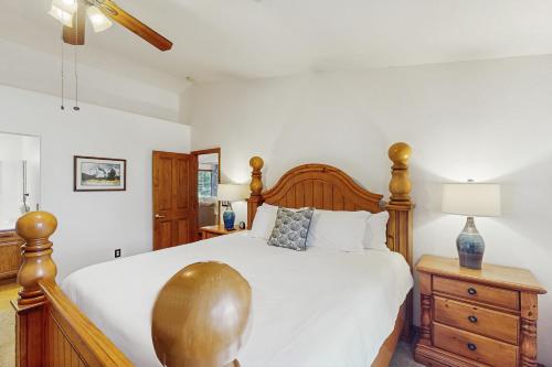 a bedroom with a large bed with a wooden headboard at Wandering Pine Retreat in Show Low