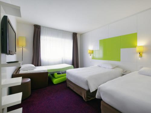 Ένα ή περισσότερα κρεβάτια σε δωμάτιο στο ibis Styles Chalon sur Saône