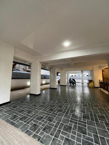 an empty room with a tile floor in a building at Hotel Sai Residency in Pune