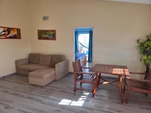 a living room with a couch and a table at Nos Krusero Apartments in Sabana Westpunt