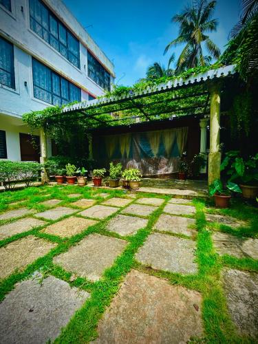 a patio with grass and plants in front of a building at Morjim Pride in Morjim