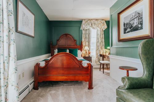 a bedroom with a bed and a chair at The Underwood-Hale House in Providence