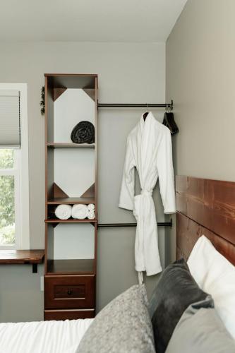 a bedroom with a white robe hanging on a wall at Sonlit Retreats in Skyline