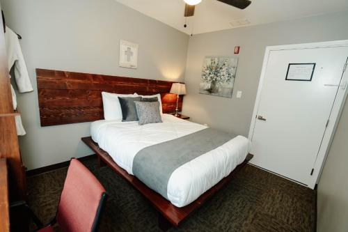 a bedroom with a large bed and a red chair at Sonlit Retreats in Skyline