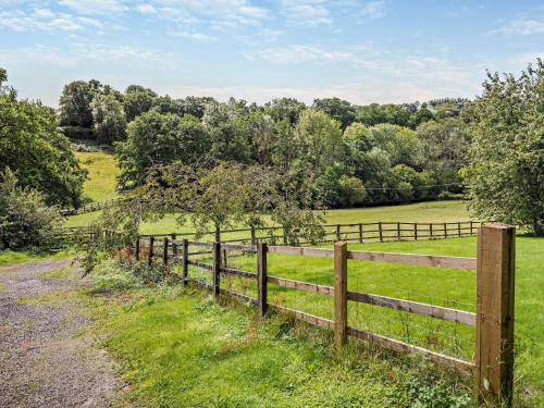 a wooden fence in a field with trees at 1 bed in Bampton LIMKC in Bampton