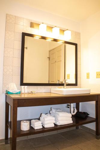 a bathroom with a sink and a mirror and towels at Country Inn & Suites by Radisson, Carlisle, PA in Carlisle