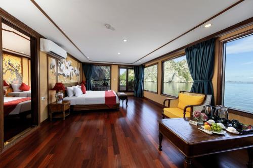 a hotel room with a bed and a table at Verdure Lotus Grandeur Cruise on Ha Long Bay in Ha Long