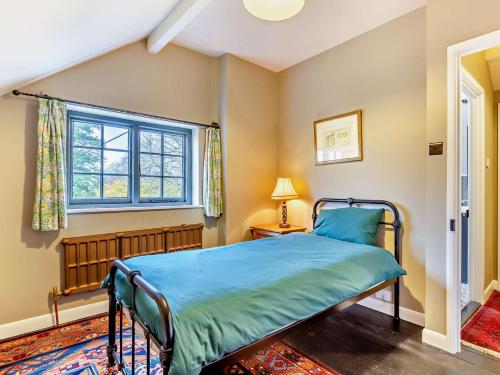 a bedroom with a bed and a window at 2 Bed in Withypool 77362 in Withypool
