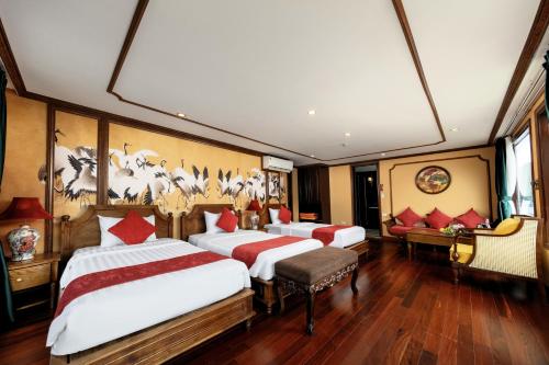 a room with three beds and a desk at Verdure Lotus Grandeur Cruise on Ha Long Bay in Ha Long