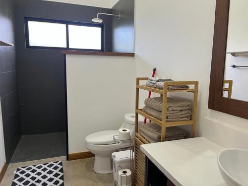 a bathroom with a toilet and a sink at Casa Flor in Playa Avellana
