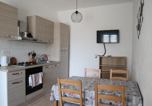 a kitchen with a table and chairs in a kitchen at Villa Francesca A in Roccagloriosa