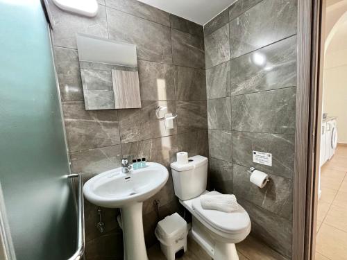 a bathroom with a toilet and a sink at STAY Symphony Apartment in Protaras