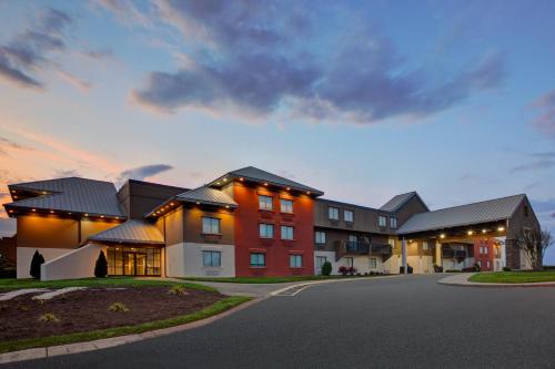 a large apartment building with a street in front at Holiday Inn Express Nashville Airport by IHG in Nashville