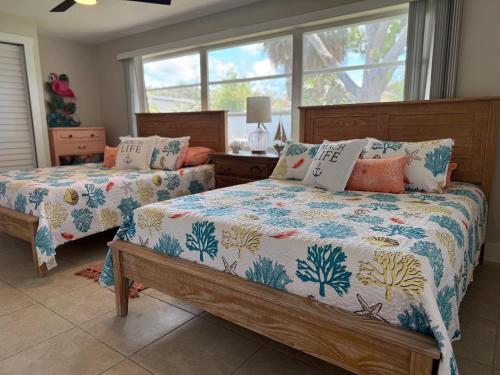 a bedroom with two beds and a window at Luxury Coastal Retreat in Largo