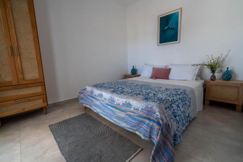 a bedroom with a bed with a blanket on it at La Calma in Palekastron