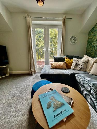 a living room with a coffee table with a book on it at Modern 2Bed Netflix & Free Parking Telford Gem in Dawley