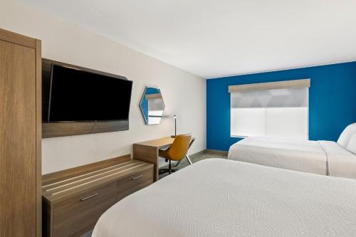 a hotel room with two beds and a flat screen tv at Holiday Inn Express & Suites Fairmont by IHG in Fairmont