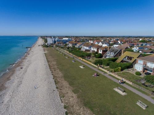 an aerial view of a beach with houses and the ocean at 3 The Moorings, East Wittering in East Wittering