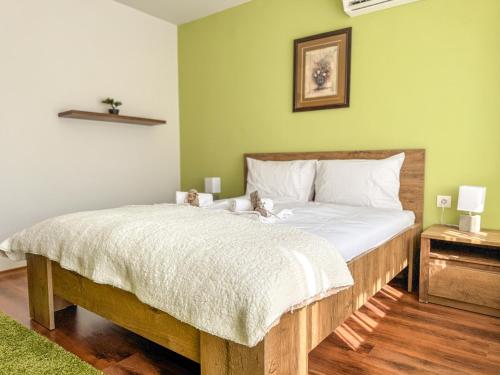 a bedroom with a bed with two teddy bears on it at 2BR Vintage Apt next to Tsar Simeon Garden by Flat Manаger in Plovdiv