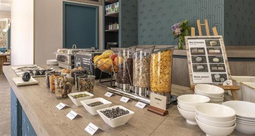 a table with food and other items on it at Best Western Poitiers Centre Le Grand Hôtel in Poitiers