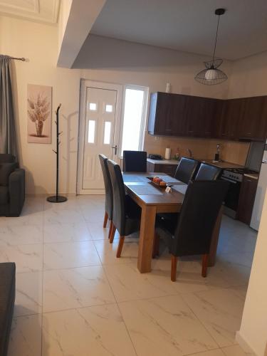 a kitchen and dining room with a table and chairs at Meteora view Guesthouse in Kalabaka