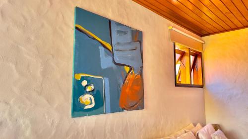 a painting on the wall of a room at Pousada Hortelã in Campos do Jordão