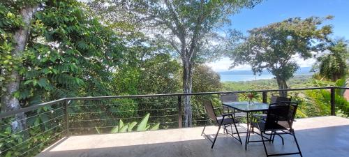 a patio with a table and chairs on a balcony at Casa Vista Pavones in Pavones