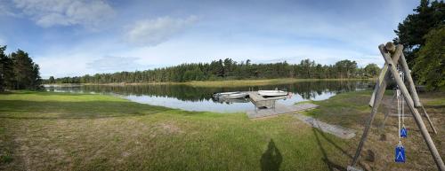 a boat sitting on the shore of a lake at Holmströms stugor in Eckerö
