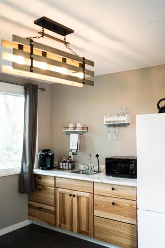 a kitchen with a sink and a microwave at Sonlit Retreats in Skyline
