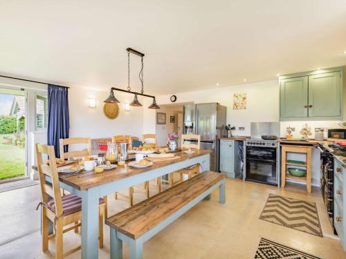 a kitchen with a large wooden table and chairs at 4 Bed in Blandford Forum 76544 in Twyford