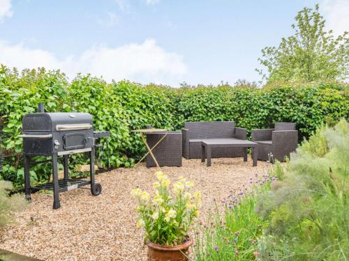 a barbecue and a grill in a garden at 4 Bed in Blandford Forum 76544 in Twyford