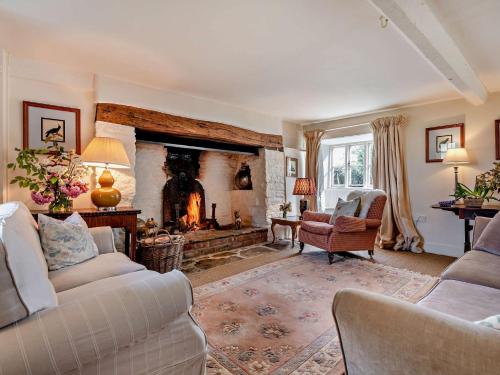 a living room with a fireplace and two couches at 5 Bed in Sturminster Newton 76458 in Lydlinch