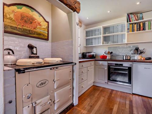 a kitchen with white cabinets and a stove top oven at 5 Bed in Sturminster Newton 76458 in Lydlinch