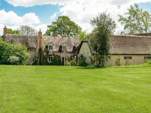 an old stone house with a large grass field at 5 Bed in Sturminster Newton 76458 in Lydlinch