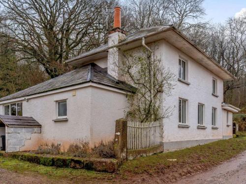 an old white house with a chimney at 4 Bed in Monmouth 42868 in Cwmcarvan