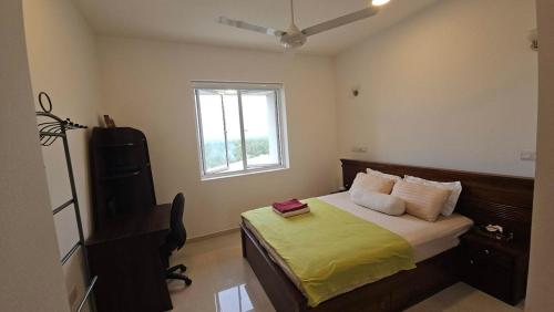 a bedroom with a bed and a desk and a window at Ocean Paradise Luxury in Nikawatawana