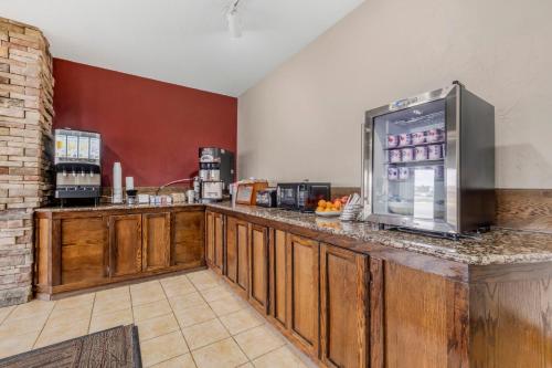 a kitchen with a counter with a refrigerator at Red Roof Inn Dumas in Dumas