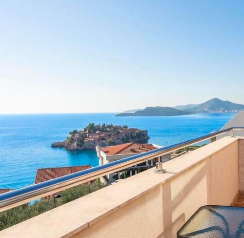 a balcony with a view of the ocean at MILA Adriatic sea view apartment, Sveti Stefan in Sveti Stefan