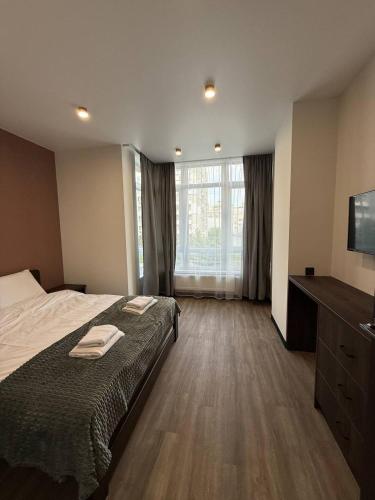 a hotel room with a bed and a television at Апартаменти ВІП вул Під Голоском 15 б 9-1 in Lviv