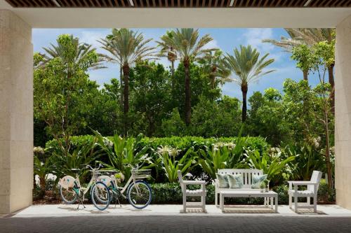 two bikes parked next to chairs and palm trees at Fort Lauderdale Marriott Pompano Beach Resort in Pompano Beach
