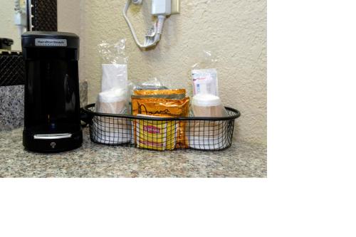 a counter top with a coffee maker and some food at Red Roof Inn Hot Springs in Hot Springs