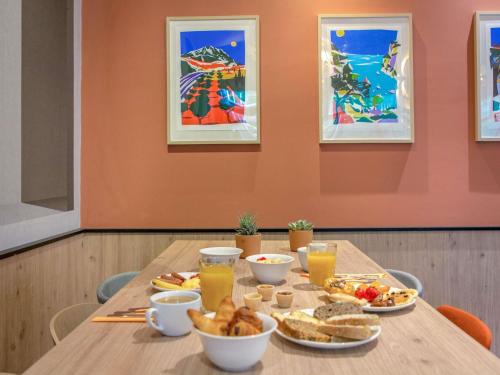 a table with breakfast foods and drinks on it at Novotel Aix-en-Provence Pont de L'Arc in Aix-en-Provence