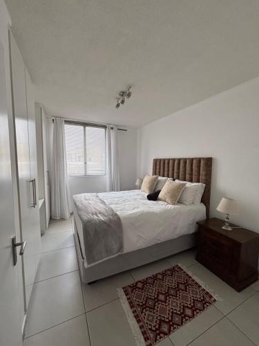 Ένα ή περισσότερα κρεβάτια σε δωμάτιο στο Cozy CBD Apartment - Windhoek