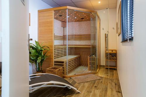 a room with a shower with a bench in it at La Villa Perchée, Appartements Élégants, sauna Privé, sport, terrasses et Vue Panoramique, Parking protégé, proche PARIS in Saint-Prix