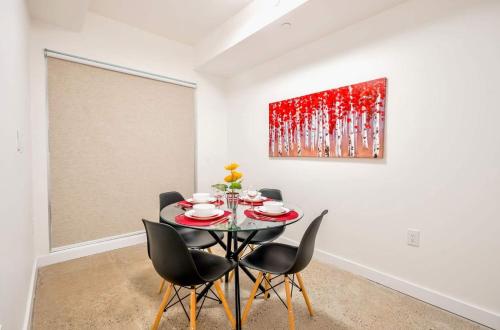 a dining room with a table and chairs and a painting at Peaceful 2BR Basement Suite Near Downtown Toronto - The Roland in Toronto