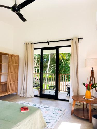 a bedroom with a bed and a sliding glass door at Jungle Tiny House in El Valle