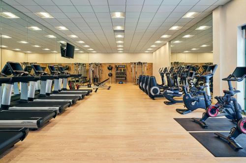 a gym with rows of treadmills and exercise bikes at The Westin Denver Downtown in Denver