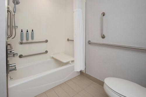 a bathroom with a tub and a toilet and a sink at Courtyard by Marriott Houston City Place in Spring