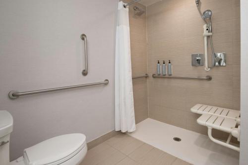 a bathroom with a toilet and a shower at Courtyard by Marriott Houston City Place in Spring